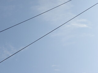Electrical cables on blue sky background