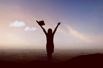 Silhouette of student woman with book and excited expression