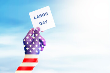 Hands with American flag skin with Labor day message