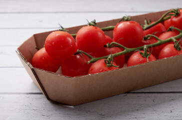 Tomato branch isolated on a wooden background.