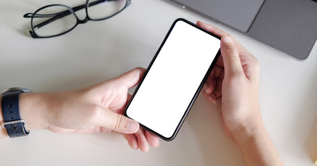 Top view Woman sitting and holding blank screen mock up mobile phone