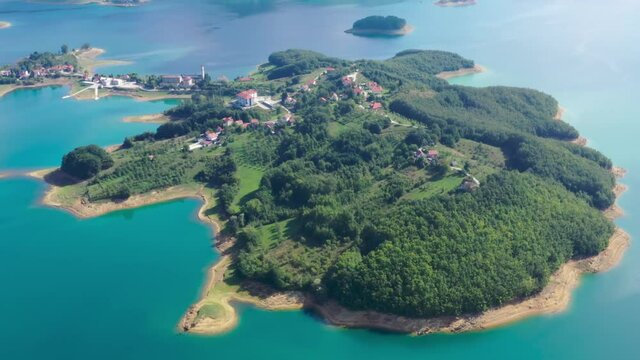 Island of the town of Scit in Bosnia and Herzegovina Rama lake, Aerial flyover shot