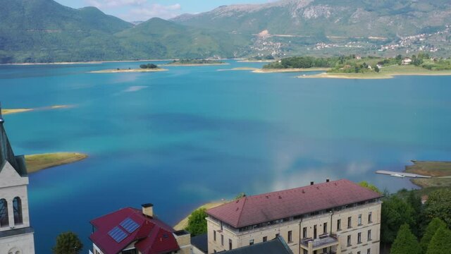 Franjevacki Samostan Monastery grounds in Bosnia and Herzegovina's Rama lake, Aerial dolly out shot