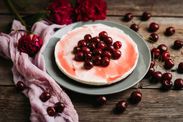 Fresh cheesecake with cherries on the rustic background. Selective focus. Shallow depth of field.