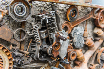 Rusted metallic car parts in garage.