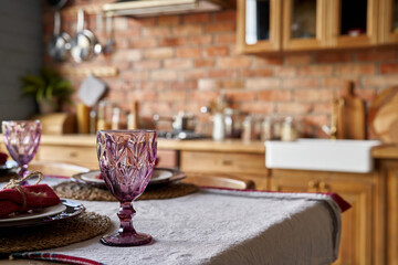 Serving for dinner on kitchen table. Warm kitchen background interior. Mockup.