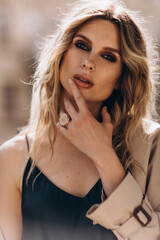 Fashionable portrait of a stylish blonde woman in elegant totall beige look and smoky eyes makeup. Spring - autumn fashion concept. Soft selective focus.