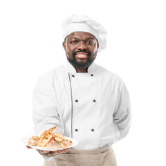 Male African-American chef with tasty dish on white background