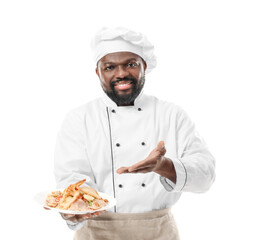 Male African-American chef with tasty dish on white background
