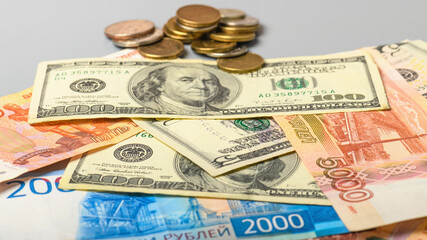 Cash banknotes and coins background. The background of the American and Russian money banknotes and coins. Dollars and rubles background.