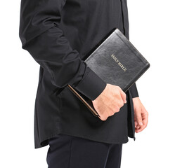 Handsome young priest with Bible on white background
