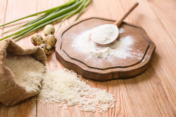 Board with rice flour and eggs on table