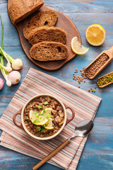 Pot of tasty lentils soup with bread on table