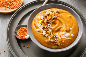 Bowl of tasty lentils soup on table