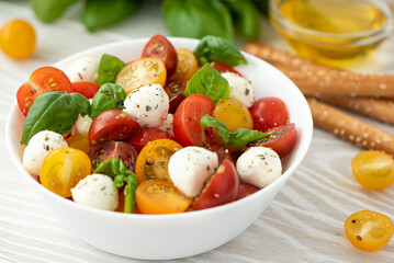 Italian salad with cherry tomatoes, mozzarella and basil
