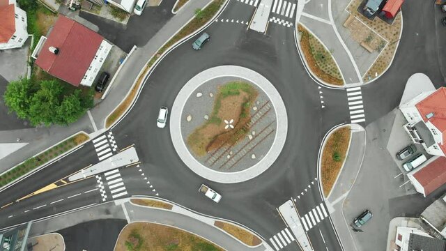 Cars Driving On The Roundabout In Arendal, Norway At Daytime - spinning clockwise top view