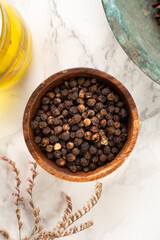 Black pepper and spice concept in wooden bowl