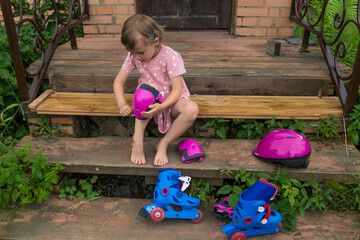 A little girl is wearing protection for roller skating