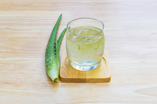 a glass of watermelon with a green leaf on a wooden cutting board - Aloe Vera for drinking on wood t