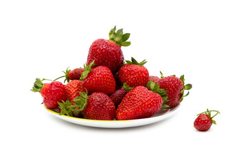 Fresh, ripe, juicy, tasty red strawberries with green stems in a white bowl on a white isolated background. Summer seasonal natural berries for a healthy diet