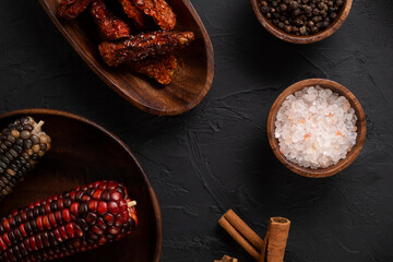 Food concept with wooden presentation board on black stone floor