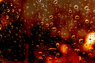 water drops on glass window with bokeh lights	
