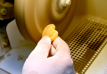  Polishing of amber billet on a polishing machine. Jewelry workshop