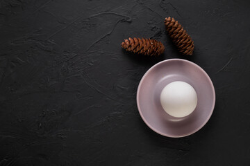 Egg concept on black stone floor ( with copy space )