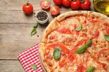 Delicious pizza Margherita and ingredients on wooden table, flat lay