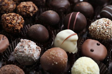 Different tasty chocolate candies as background, closeup