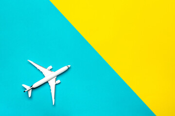 Fototapeta premium Toys kids aircraft backdrop. White toy airplane in close up view with copy space for flight air plane travel concept.