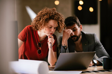 Colleagues working on the project. Businesswoman and businessman discussing work in the office.	
