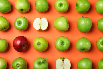 Tasty green apples and red one on orange background, flat lay