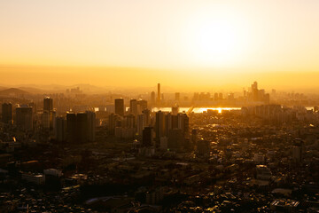 Downtown Seoul and the Han river at sunset, with skyscrapers and a layer of fine dust pollution, viewed from the Namsan Tower, 2018