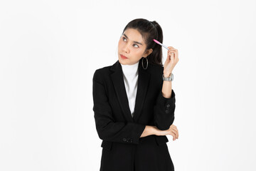 Portrait of attractive young Asian business woman holding pen and having idea posing over white isolated background.