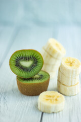 Sliced kiwi and banana close-up on a light background
