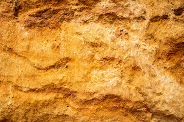 Sandstone wall background. Nature yellow sand textured background 