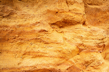 Sandstone wall background. Nature yellow sand textured background 