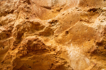 Sandstone wall background. Nature yellow sand textured background 