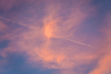 Pink sunset sky with pearly clouds