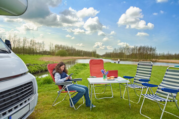 Family vacation, RV travel with kids, happy mother with children have fun on holiday trip in motorhome, camper exterior
