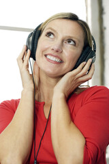 Woman listening to music on the headphones