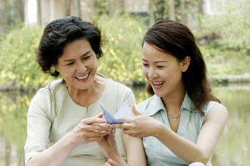 Mother and daughter making origami