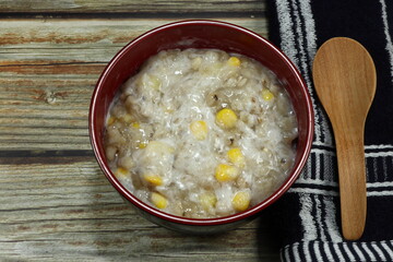 Traditional Thai sweet dessert made from coconut milk, Job's tear, fresh sweet corn, taro, potato and syrup. Famous local tropical snack in Asia. 