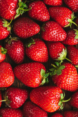 Fresh strawberries as a background. Food background fresh organic strawberries, vertical orientation