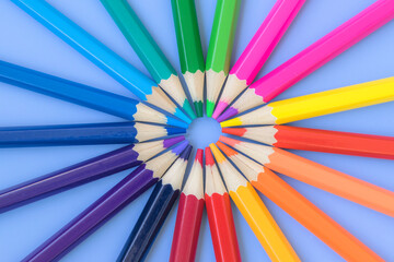 Fototapeta premium Colored pencils laid out around. Stationery for school and kindergarten. Drawing tools. Products for creativity.