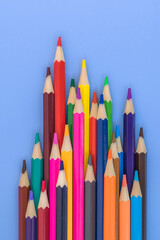 Multi-colored pencils laid out in random order. Template for stationery. Products for drawing and creativity.