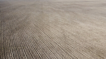 Arable field, aerial view. Landscape. Agricultural field as a background.