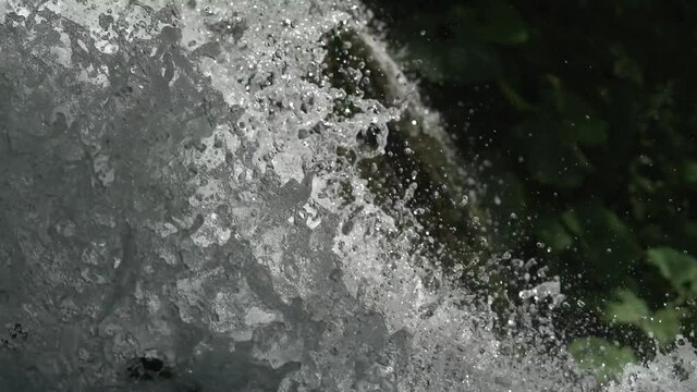 Waterfall in the freen forest. Drops of water on close up shot. Nature background