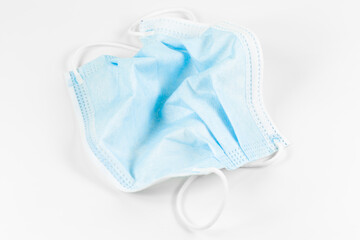 a single crumbled surgical masks isolated on white background